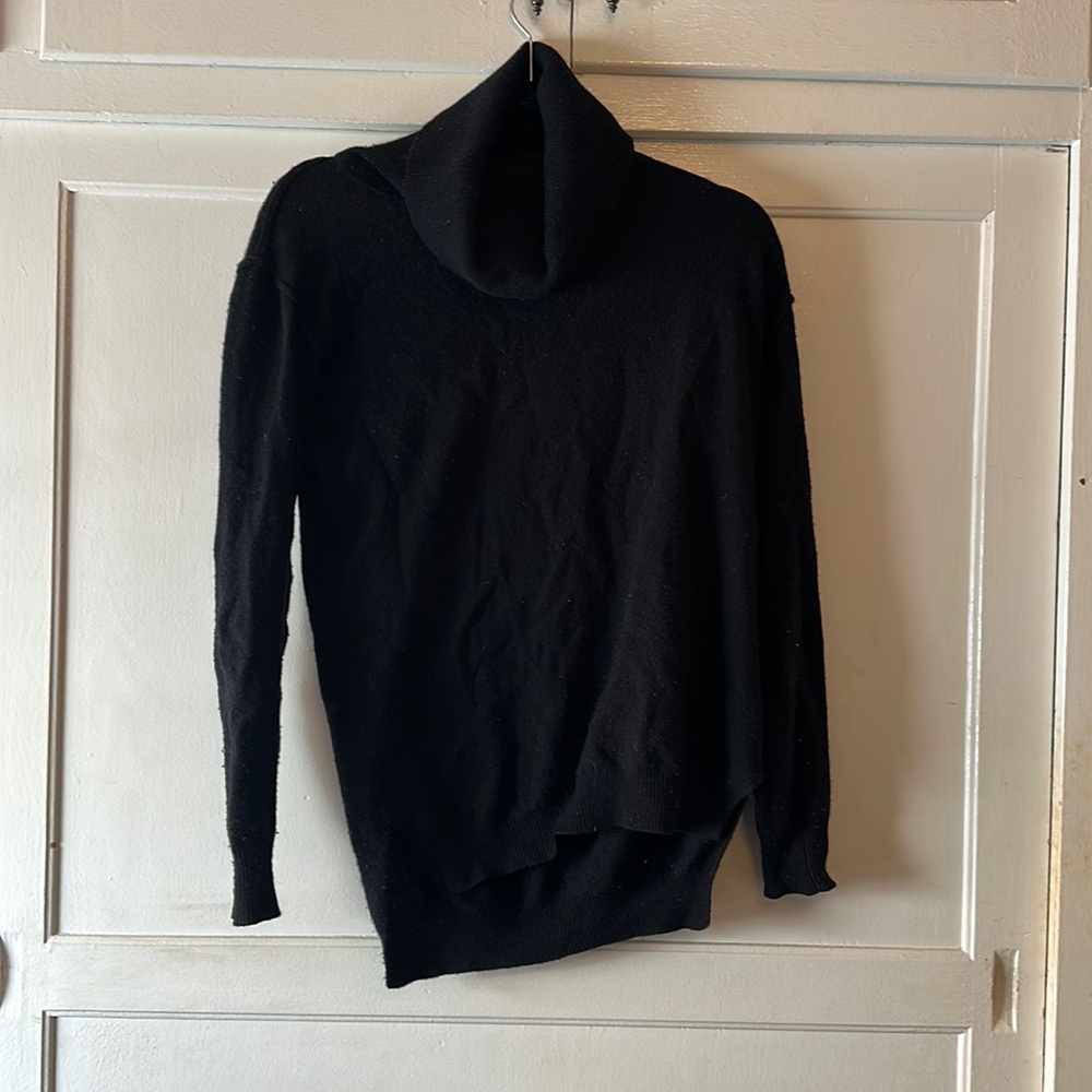 Perfect everyday turtleneck black cashmere sweater with split bottom at seam